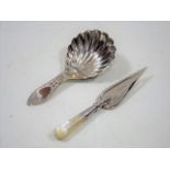 A Silver Shell Shaped Caddy Spoon Twinned With A M