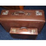 A Small Leather Suitcase & One Other