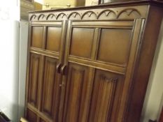 An Oak Double Wardrobe With Linen Fold Doors