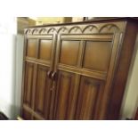 An Oak Double Wardrobe With Linen Fold Doors