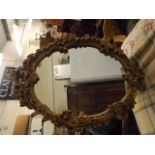 An Oval Gilt Framed Mirror