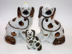 A pair of copper lustre Staffordshire pottery dogs