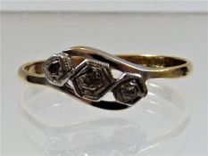 An 18ct gold ring with three small diamonds