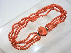 A 19thC. set of coral beads with a carved coral ca