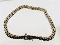 A 14k Columbian gold bracelet set with emeralds
