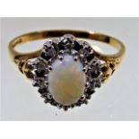 A 9ct gold ring set with opal & diamond