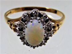 A 9ct gold ring set with opal & diamond