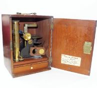 An antique brass microscope with mahogany box