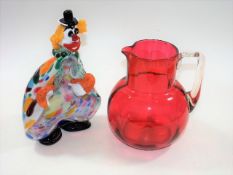 A Victorian cranberry glass jug twinned with a Mur