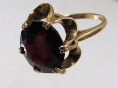 A large 9ct gold ring with garnet