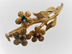 A Victorian gold floral brooch with ruby, sapphire