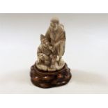 An antique Japanese carved ivory figure on carved