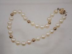 A cultured pearl bracelet with gold fittings