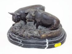 A bronze figurative sculpture of pigs after Moigni