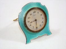 An art deco silver travel clock with enamelled fro