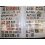 A large album of world stamps including Chinese 19thC.