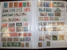 A large album of world stamps including Chinese 19thC.