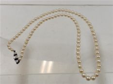 A cultured pearl necklace set with 18ct sapphire &