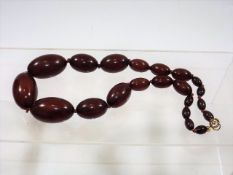 An early 20thC. bakelite red amber necklace