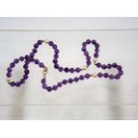 An amethyst necklace spaced with gold & pearl bead