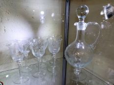 An etched decanter set with six glasses