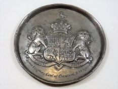 A pewter plaque with coat of arms inscribed James