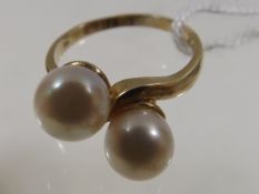A 9ct gold ring set with two cultured pearls