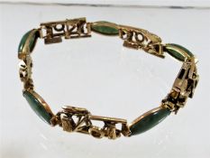 A c.1920's 18ct gold & jade bracelet