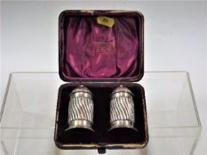A pair of silver salts in velvet case