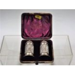 A pair of silver salts in velvet case