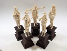 A 19thC. European carved ivory band on carved plin