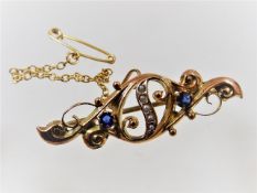 A Victorian gold brooch set with sapphire & natura