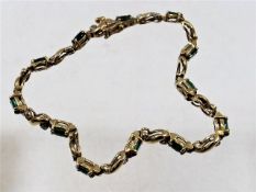 A 14ct gold bracelet set with emerald & diamonds