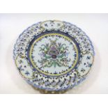 A continental faience charger with reticulated edg