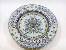 A continental faience charger with reticulated edg