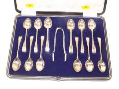 A boxed set of twelve silver teaspoons & tongs