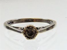 A white metal ring marked .875 set with white ston