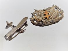 A silver bi plane brooch twinned with white & yell