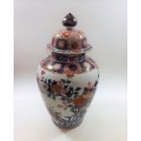 A large Japanese lidded Imari vase, repair to rim