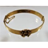 An 18ct gold antique bangle set with champagne coloured stone