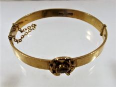 An 18ct gold antique bangle set with champagne coloured stone