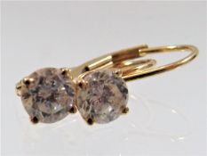A pair of US 14k gold earrings set with diamonds