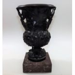 A 19thC. bronze vase on marble base with horn anim