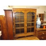 A walnut veneer low level bookcase