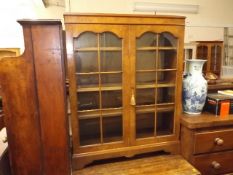 A walnut veneer low level bookcase