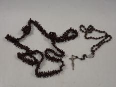 A seed necklace twinned with necklace & crucifix