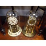 Two German style anniversary clocks with glass dom