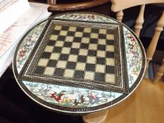A decorative chess board depicting Asian hunting s