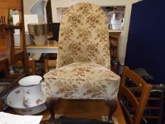 A low level early 20thC. upholstered chair