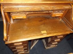 A Lebus oak tambour topped twin pedestal desk with